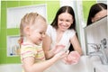 Kid girl washing hands with soap in bathroom Royalty Free Stock Photo