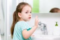 Kid girl washing her face and hands in bathroom Royalty Free Stock Photo