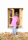 Kid - girl watching into window Royalty Free Stock Photo