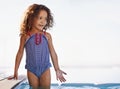 Kid, girl and water with face, swimwear and blue summer sky for relax and smile. Child, youth and sunshine with Royalty Free Stock Photo