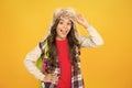 Kid girl wear hat with ear flaps. Northern region fashion. Eskimo style. Soft furry accessory. Child schoolgirl long Royalty Free Stock Photo