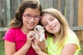 Kid girls playing with puppy pet chihuahua