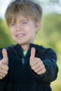 A kid giving a two thumbs up Royalty Free Stock Photo