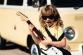 Kid with guitar. Portrait of 7 years old boy outdoor. Royalty Free Stock Photo