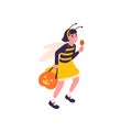 Kid in Halloween party costume of cute bee, walking with lollipop. Happy girl with pumpkin and candies running