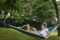 awkward kid on hammock with book away Royalty Free Stock Photo