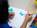 Kid hand brush and drawing paper with square color palette  for art work,back view Royalty Free Stock Photo