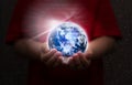 Kid hand hold hologram globe for online education environment care technology next generation concept Royalty Free Stock Photo