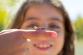 Kid hand holding grasshopper bug macro Royalty Free Stock Photo