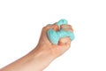 Kid hand holding and squeezing blue slime in front of a white