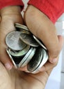 Kid hand holding stack of Indonesian Coin