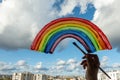 Kid hand painting colorful rainbow on window during Covid-19 quarantine at home. Stay at home due to danger of