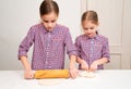 Kid hand rolled pizza dough with a rolling pin. Royalty Free Stock Photo