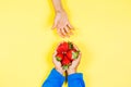 Kid hand taking strawberry from another child`s hands Royalty Free Stock Photo