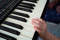 Kid hands black white piano keys synth. close-up. Royalty Free Stock Photo