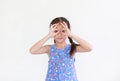 Kid with hands glasses in front of her eyes isolated on white background. Little asian girl looking through imaginary binocular Royalty Free Stock Photo