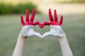 Kid hands in heart form painted in flag Monaco or Indonesia. Tourist made gesture by indonesia flag colored hands Royalty Free Stock Photo