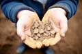 Kid hands holding poor soil, poor soil quality agricultural and environmental crisis. generative ai