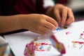 Kid hands view ,playing sticker of cartoon toy