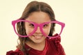 Kid happy wear cute eyeglasses accessory. Child charming smile isolated white background. Girl wear big funny eyeglasses Royalty Free Stock Photo