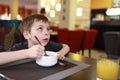 Kid has breakfast in restaurant Royalty Free Stock Photo