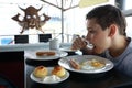 Kid has breakfast in restaurant Royalty Free Stock Photo