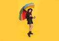 kid in hat with rainbow umbrella. autumn season. rainy weather forecast. Royalty Free Stock Photo