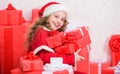 Kid helping santa. New year holiday tradition. Little santas helper concept. Kid excited about opening christmas present Royalty Free Stock Photo