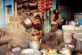 Kid helping to pour the tea-masala in a roadside cafe on poor indian street Royalty Free Stock Photo
