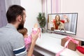 Kid with her father video chatting over a laptop with her mother. online holiday remote celebration lockdown coronavirus Royalty Free Stock Photo