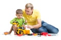 Kid and his dad repair toy tractor Royalty Free Stock Photo