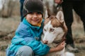 kid and his friend husky siberian dog. portrait little child boy hugging cute white brown mammal animal pet Royalty Free Stock Photo