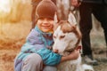 kid and his friend husky siberian dog. portrait little child boy hugging cute white brown mammal animal pet Royalty Free Stock Photo