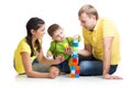 Kid with his parents playing building blocks Royalty Free Stock Photo