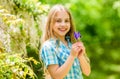 Kid hold flowers. Girl cute adorable teen nature background. Summer garden flower. Sunny summer day in nature. Walking