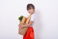 Kid holding paper grocery bag full of vegetables milk, bread. Happy child with grocery bag full of healthy food isolated on white. Royalty Free Stock Photo