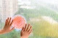Kid holding picture of smiling sun in a raining day concept of faith and optimism Royalty Free Stock Photo