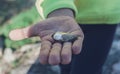 Kid holding a single small river shell outdoors, close up. Royalty Free Stock Photo