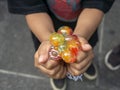 A kid holding and squeezing a colorful stress relief grape balls Royalty Free Stock Photo