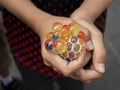 A kid holding and squeezing a colorful stress relief grape balls Royalty Free Stock Photo