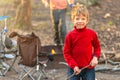 Kid holding a stick at camping ground