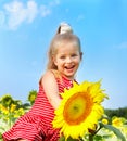 Kid holding sunflower outdoor.