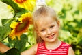 Kid holding sunflower outdoor.