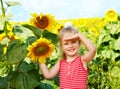 Kid holding sunflower outdoor.