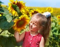 Kid holding sunflower outdoor.