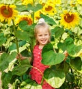 Kid holding sunflower outdoor.