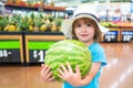 Kid holding watermelon in supermarket. Vegetables in store. Royalty Free Stock Photo