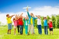 Kid holding white airplane toy and children behind Royalty Free Stock Photo