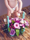 kid holding a wooden box with flowers