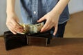 Kid holds euro banknotes in his hand and puts them in a brown wallet, concept of pocket money, theft, shopping Royalty Free Stock Photo